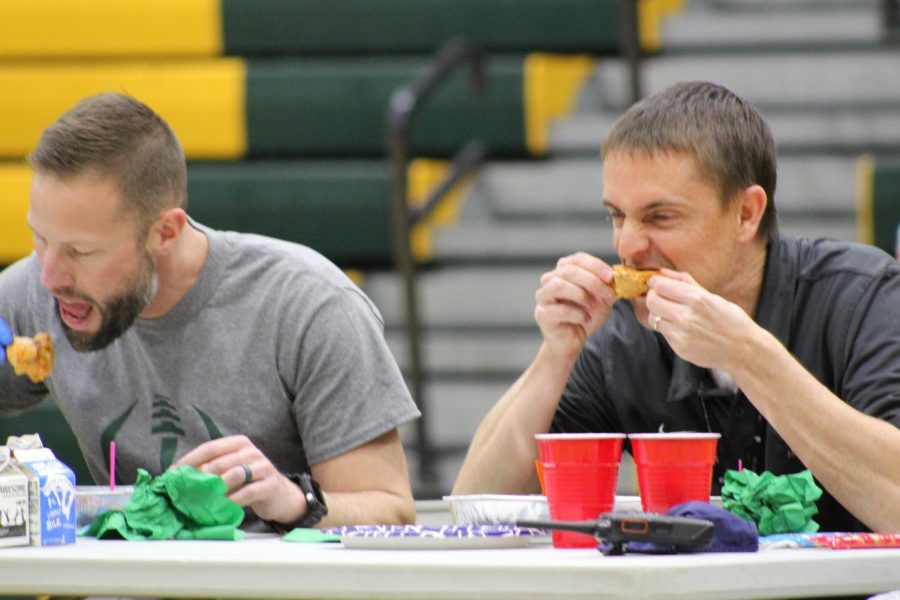 Ryan Stuart and Tyler Smith eat the hot wings.
