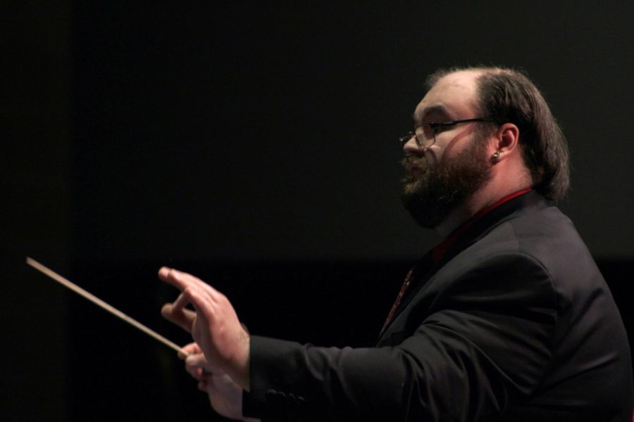 Orchestra Director Tyler Kuder conducts a song for the Dec. 13 concert.