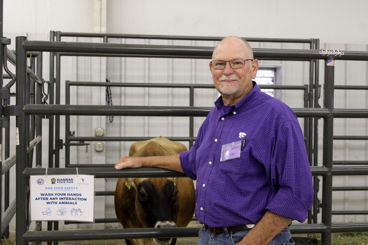 Dr. Mike Esau volunteers to educate those at the state fair by the expecting cows