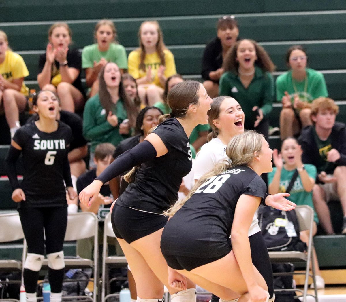The Salina South varsity volleyball team celebrates a point. South has a sense of family not common, has a want to win, Hanna Householter (24) said.
