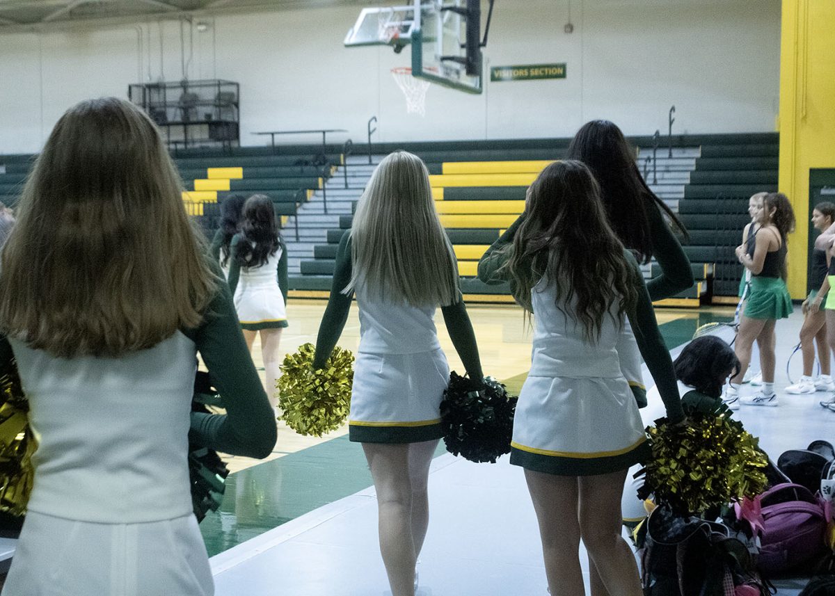 Cheerleaders walk to get their photos taken. 