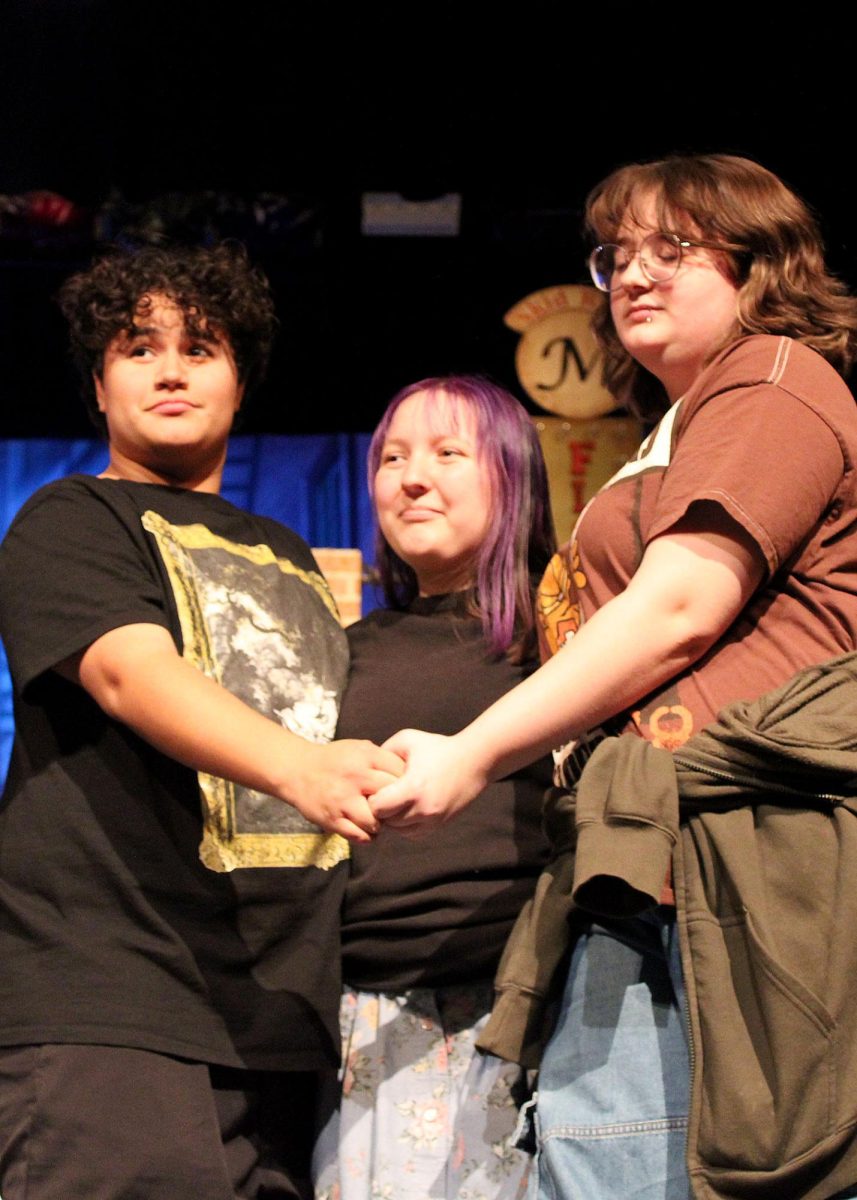 Cameron Torres ('27), Zee Cain ('26), and Jasper Carter ('26) hug after bows at rehearsal. "The show has been a great time. There's certainly been challenges but because of the insanely talented cast of actors that I'm honored to work with, everything ended up wonderful. I'm super happy to present the finished product and I'm ecstatic that I get to be part of this show," Carter said. 