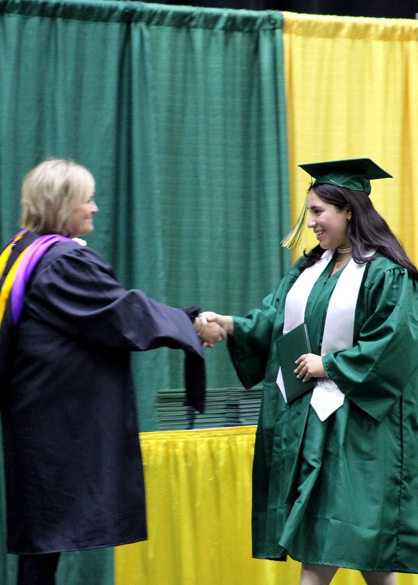 Baylee Castro ('25) shakes superintendent Linn Exline's hand.