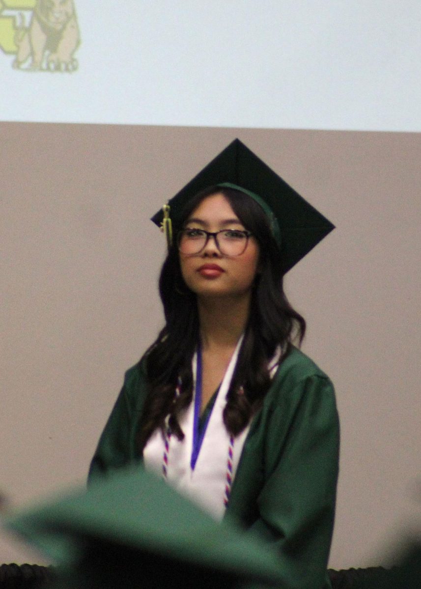 Hao Tran ('25) waits in line to walk across the stage. 