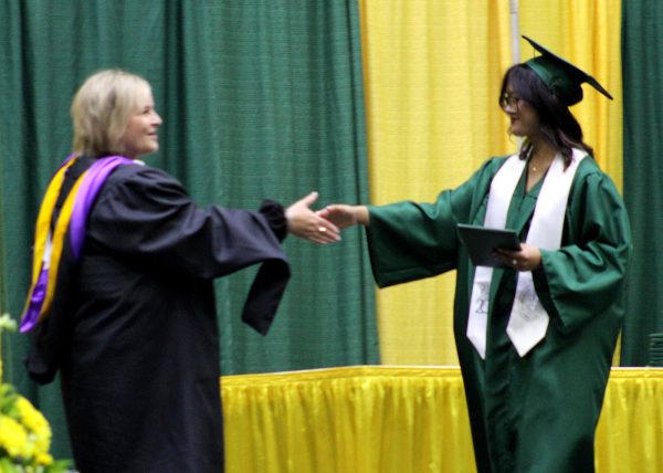Phuong Tran ('25) shakes superintendent Linn Exline's hand