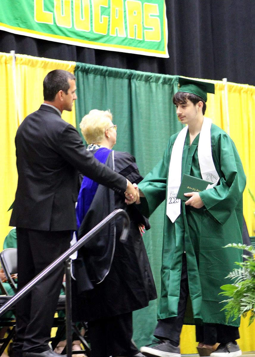 Jotis Brown ('25) shakes hands with Kanean Wendell.