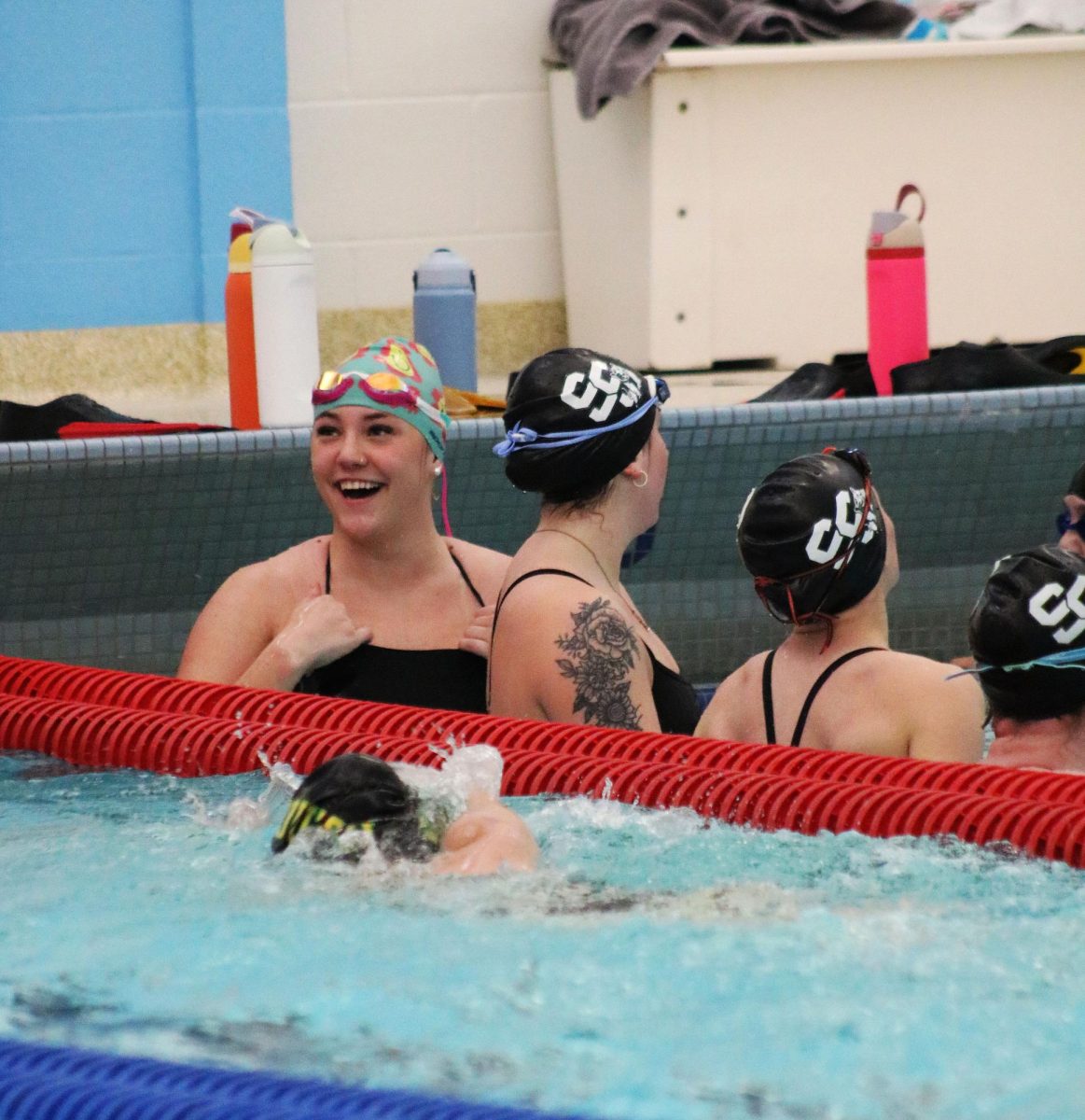 Shiloh Summers ('25) and some of the swimmers wait for instructions during swim practice.