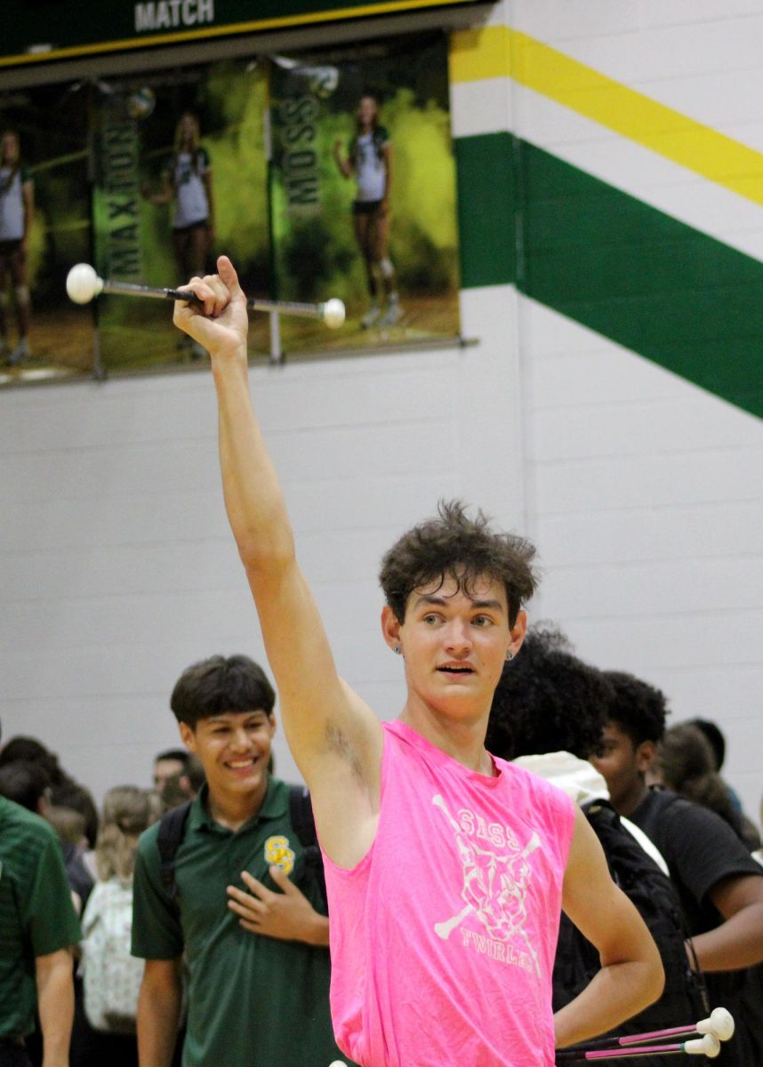 Allen Johnson ('26) finishes twirling at the end of the pep rally. 
