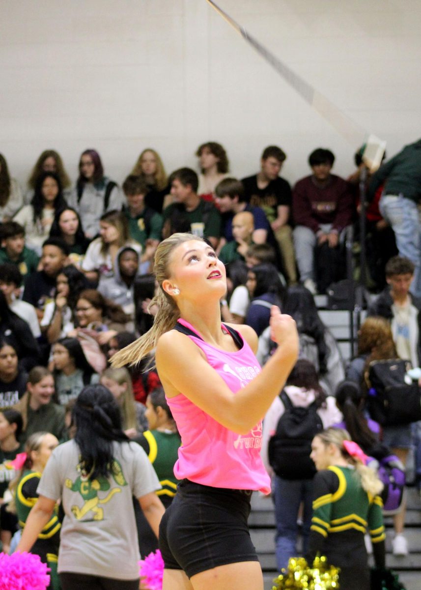 Hayden Augustine ('27) twirls while students enter for the Pep Rally.