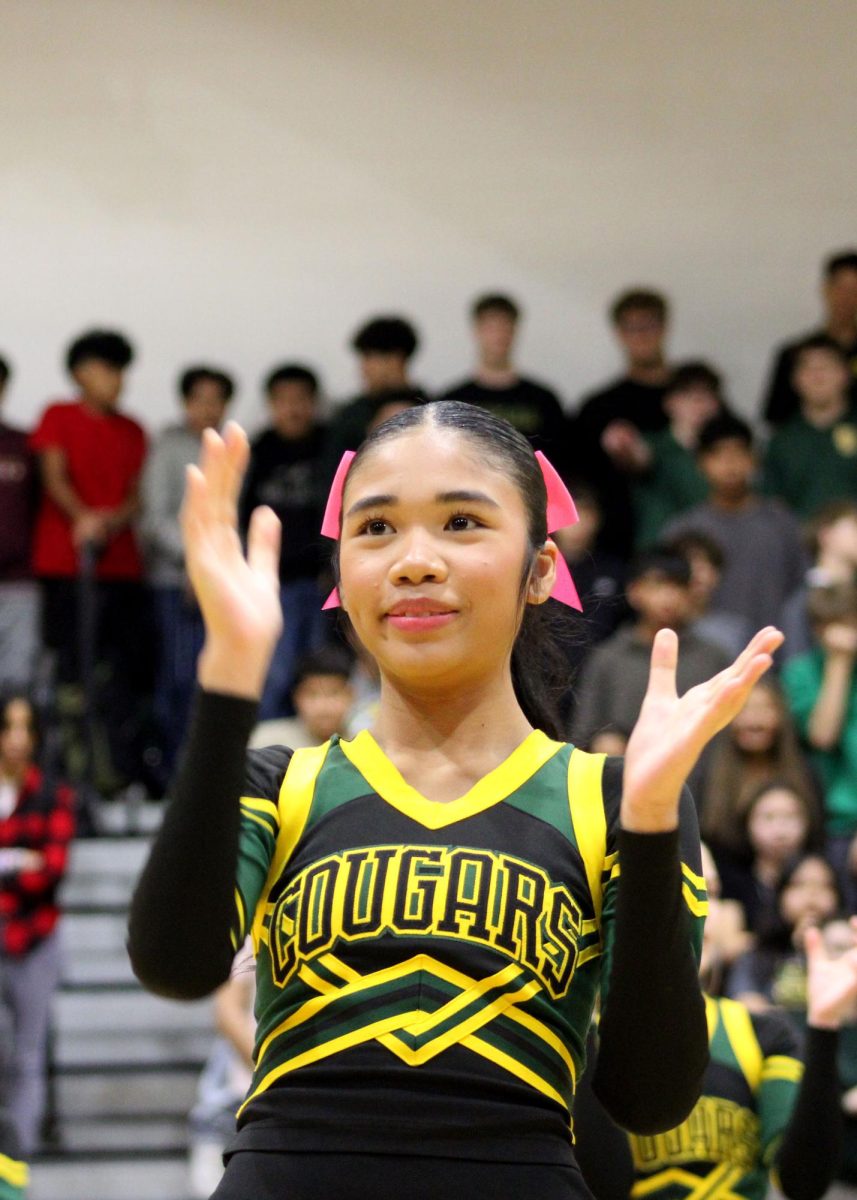 Eden Khamdalanikone ('26) claps during the cheer performance. 