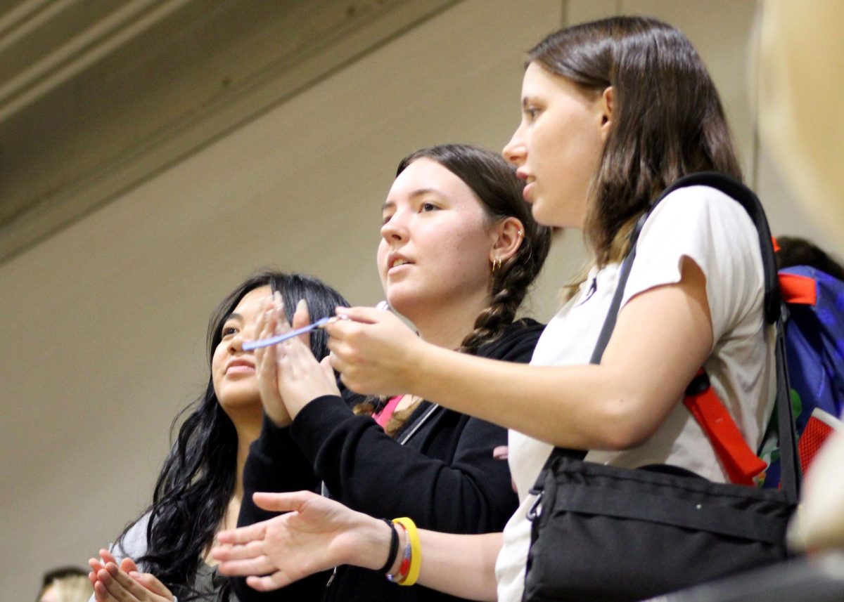 Sadie Phomchaleun ('26), Catelynn Owens ('26) and Hailey Collins ('26) watch the pep rally.
