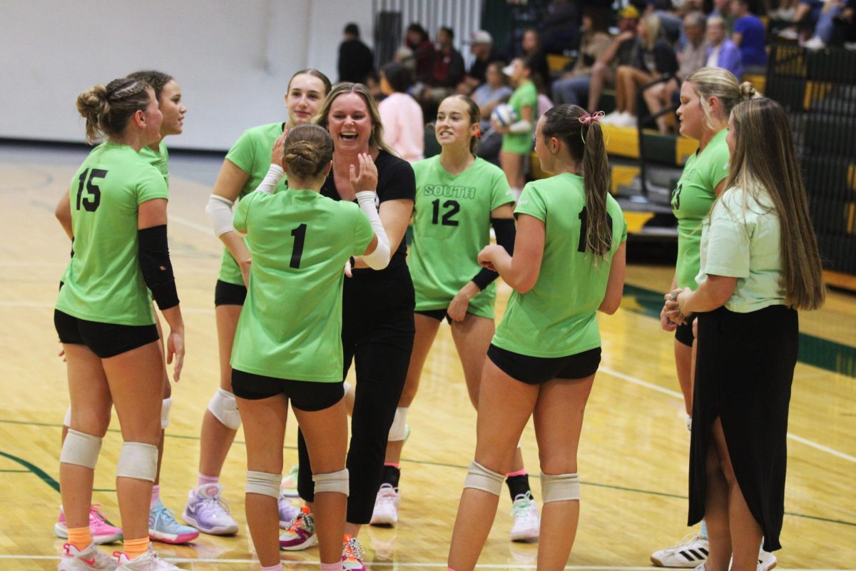 Coach Micala Anderson high fives Lauren Crow ('26)