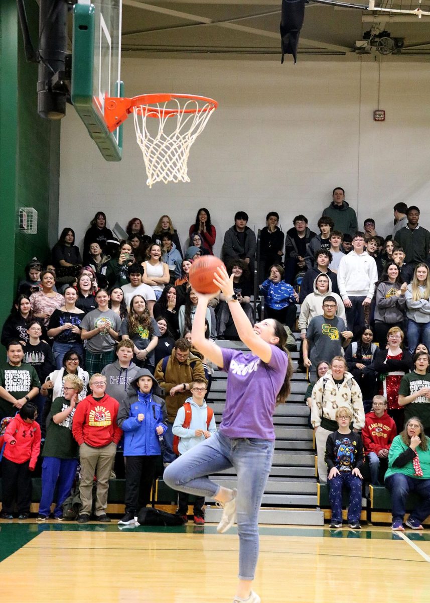 Science teacher Melissa Mahoney gets ready to shoot a basket at the start of the pep rally game. 