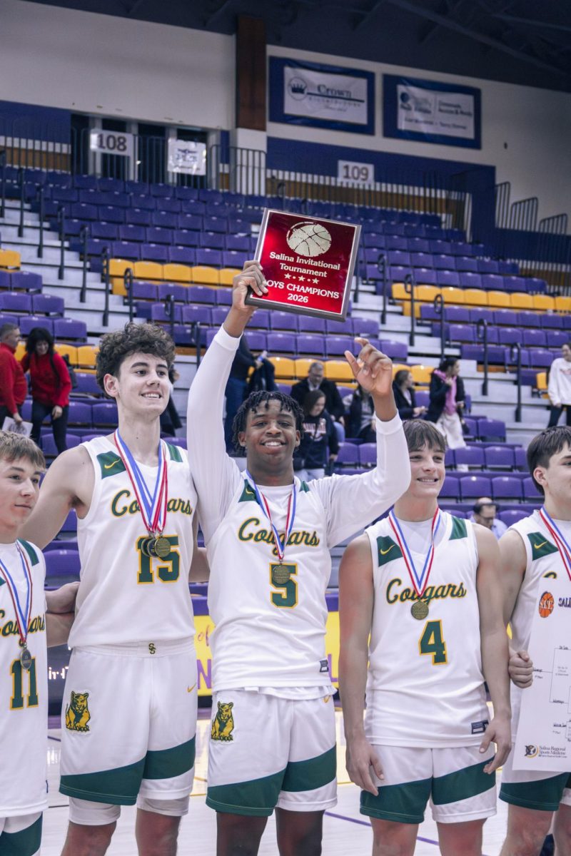 Jalen Cheeks('26) lifts the SIT trophy as he celebrates with his team.