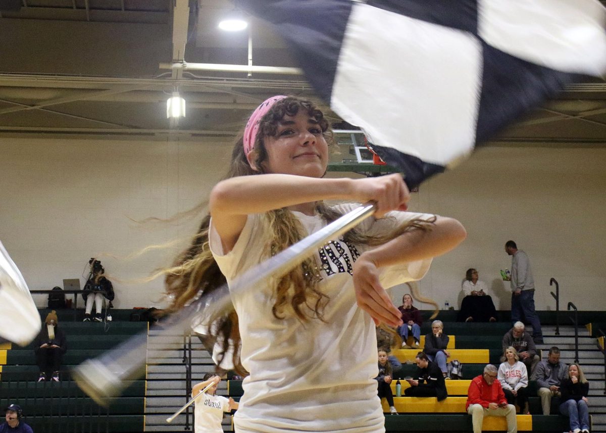 Kaleighah Perez ('27) spins her flag in time with the music.